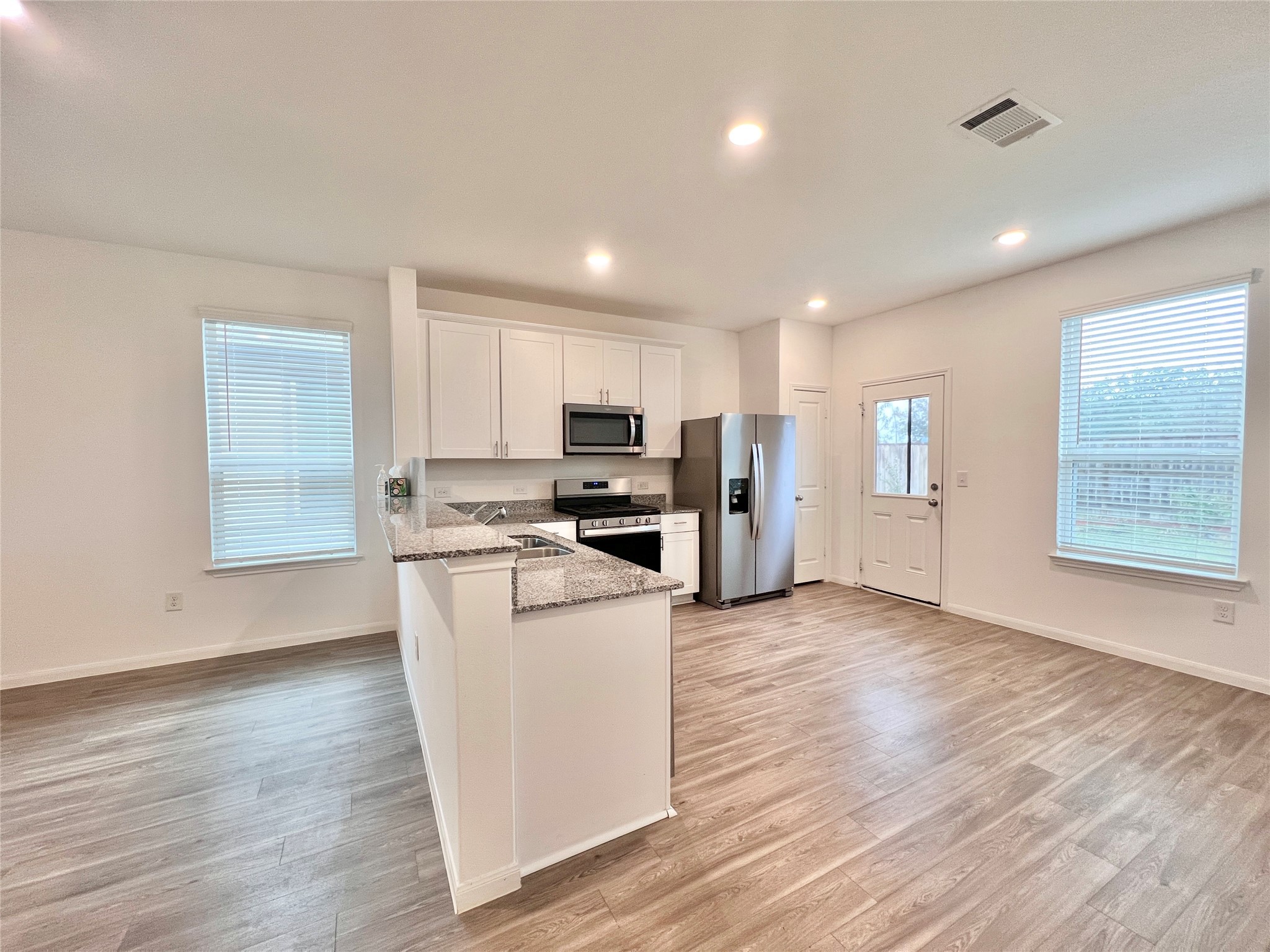17835 Plow Horse Lane Hockley, TX 77447 - Photo 6 of 41 a view of kitchen with wooden floor and electronic appliances
