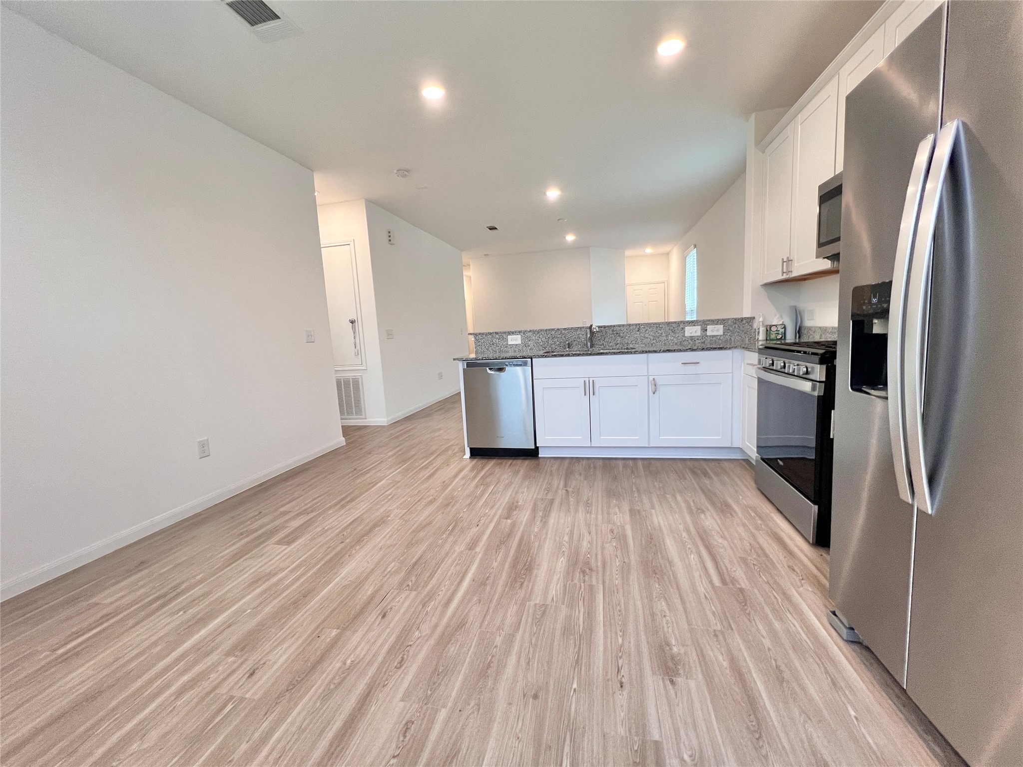 17835 Plow Horse Lane Hockley, TX 77447 - Photo 10 of 41 a kitchen with a refrigerator and wooden floor
