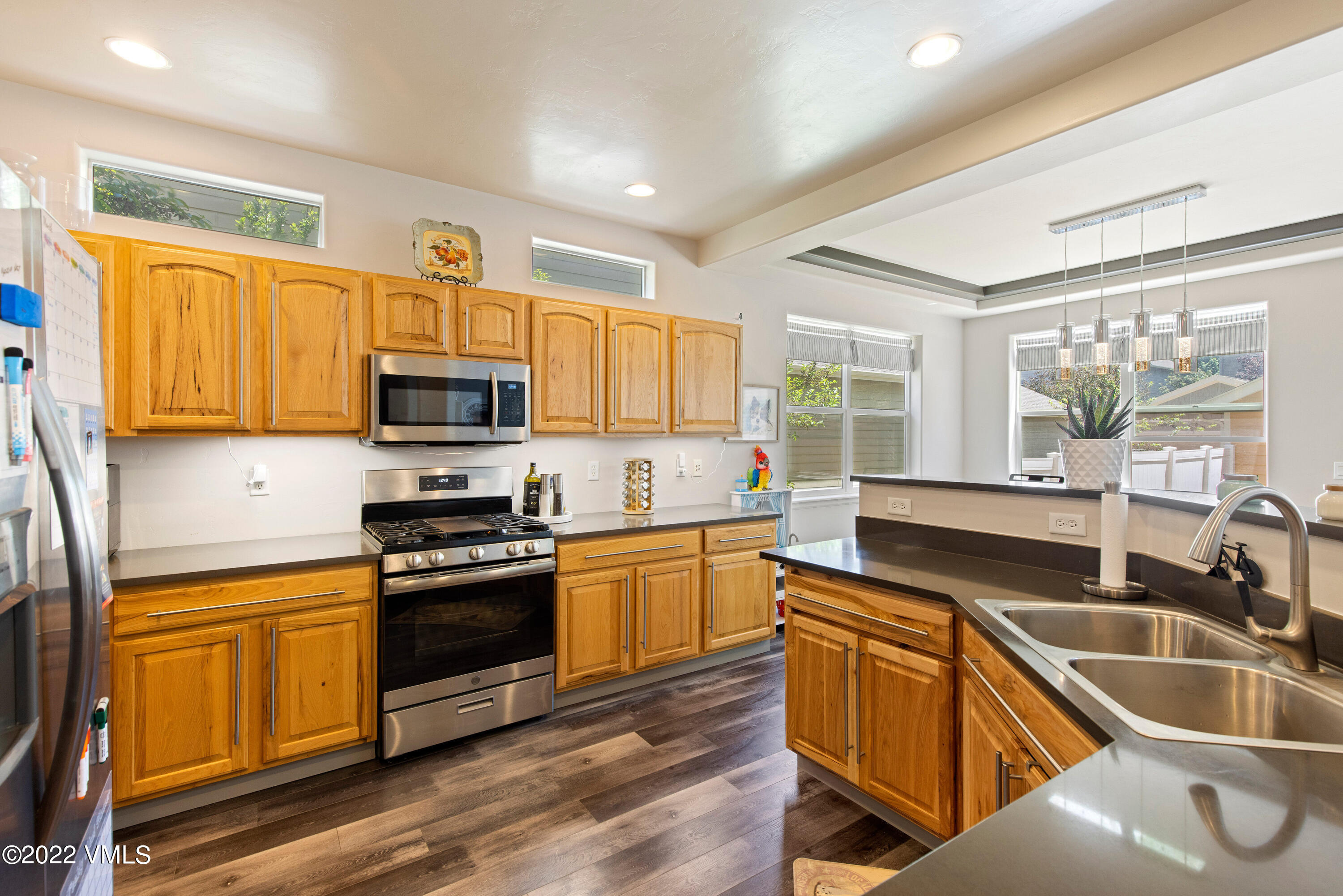 40 Eagle Ranch Road Eagle, CO 81631 - Photo 14 of 38 a kitchen with wooden floors and white appliances
