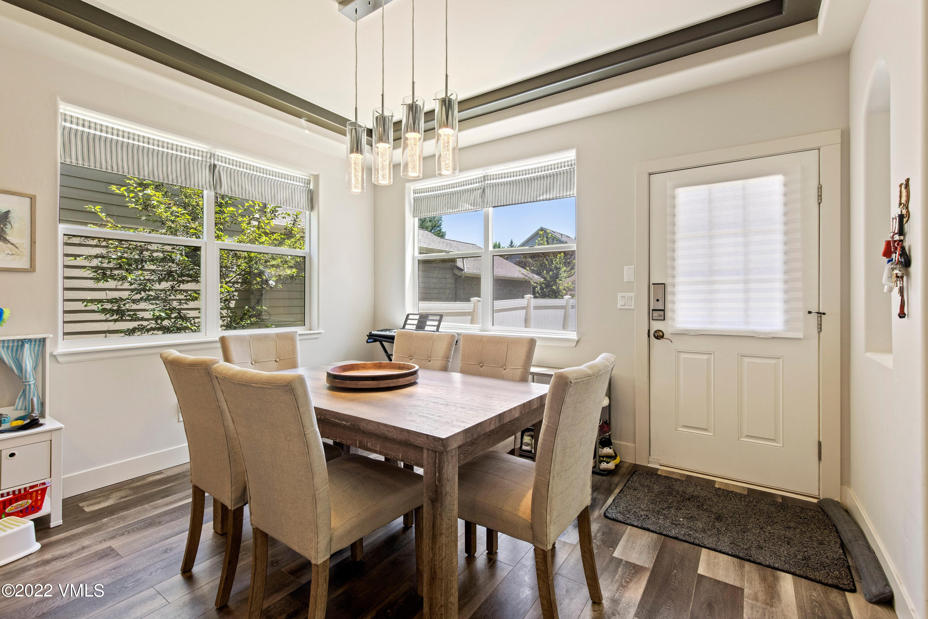 40 Eagle Ranch Road Eagle, CO 81631 - Photo 7 of 38 a dining room with furniture a chandelier and wooden floor