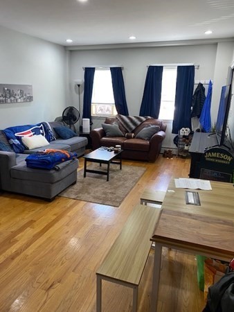 26 Maverick Street, Unit 1 Boston, MA 02128 - Photo 3 of 8 a living room with furniture and wooden floor