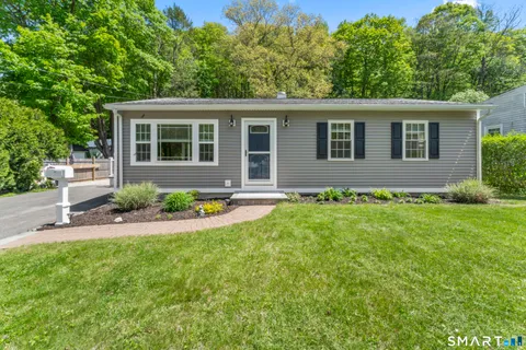a front view of house with yard and green space