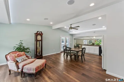 a dining room with furniture and wooden floor