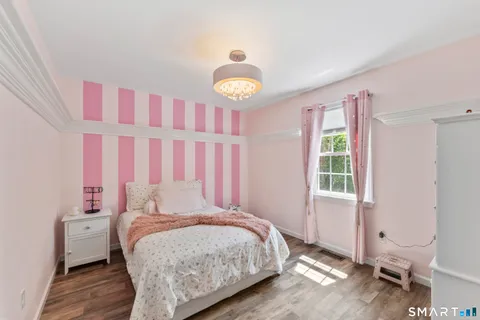a view of a room with wooden floor windows and closet