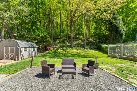 a front view of a house with a yard table and chairs