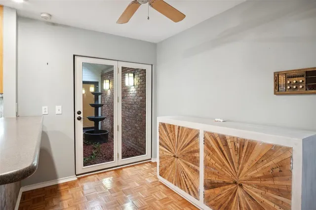 a view of a hallway with chandelier and glass door