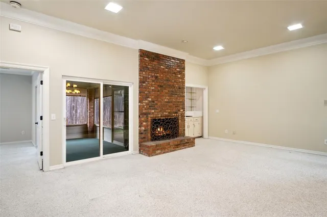 a view of an empty room with glass door