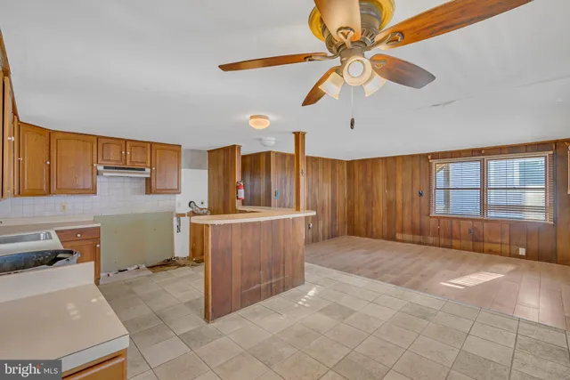 a big room with closet and a chandelier fan