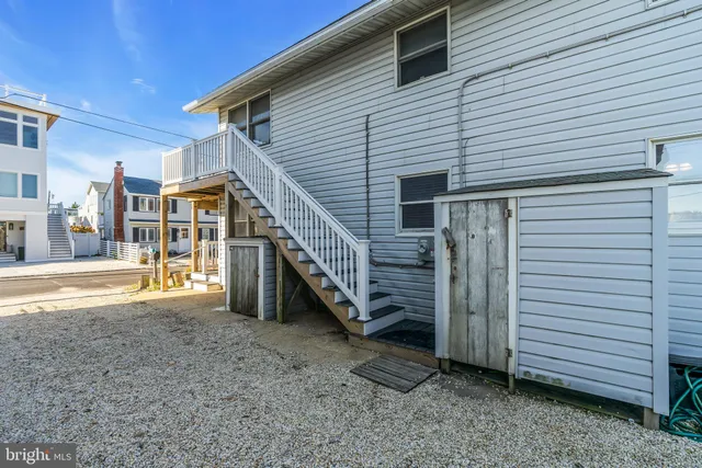 a view of a kitchen with a sink and a refrigerator
