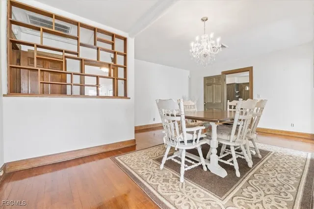 a view of a dining room with furniture and chandelier