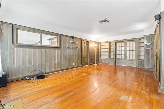 a view of an empty room with glass door
