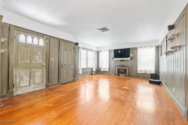 a view of empty room with a fireplace and a window