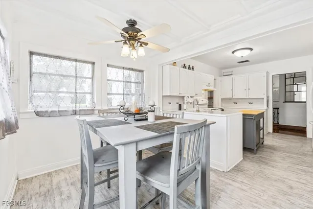 a kitchen with a table chairs a sink dishwasher a stove a refrigerator with a dining table and chairs