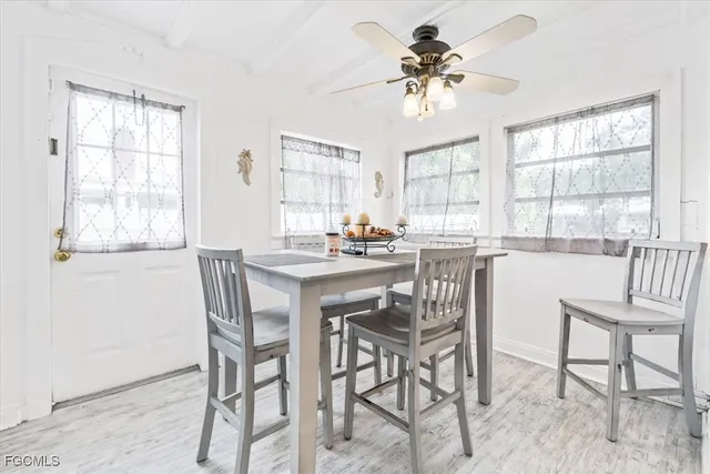 a dining room with furniture a chandelier and a window