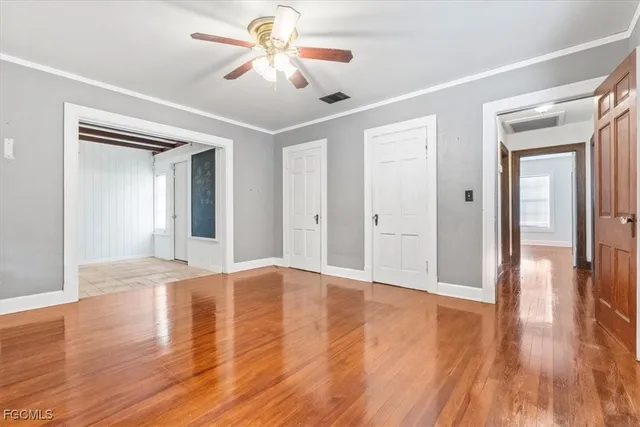 a view of an empty room with wooden floor