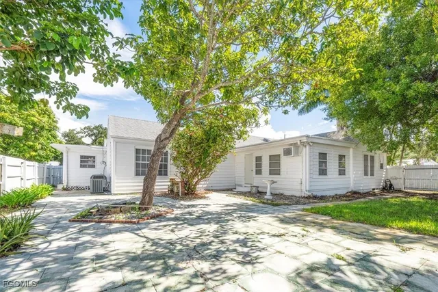 a house that has a tree in front of the house
