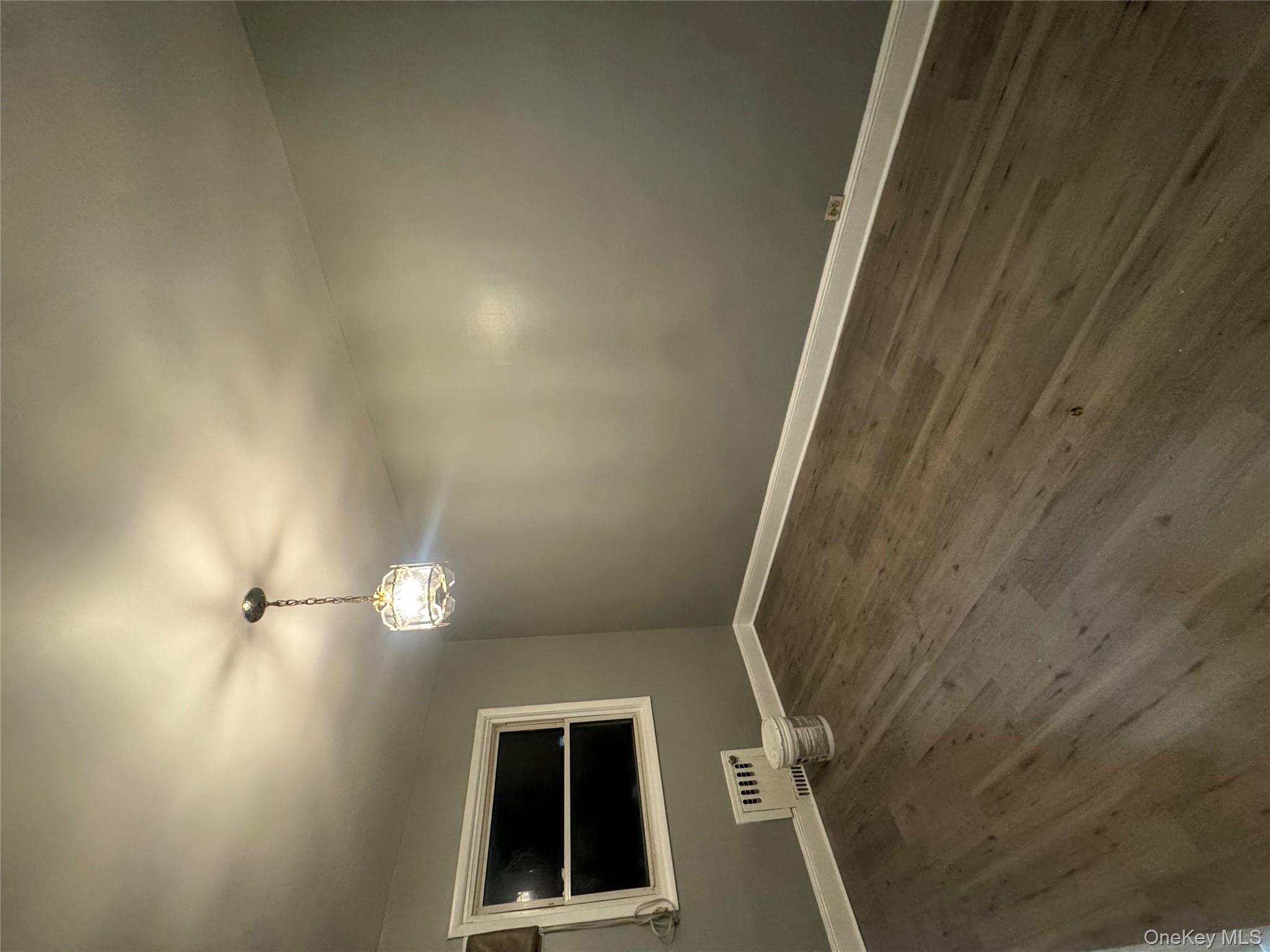 a view of a room with wooden floor and windows