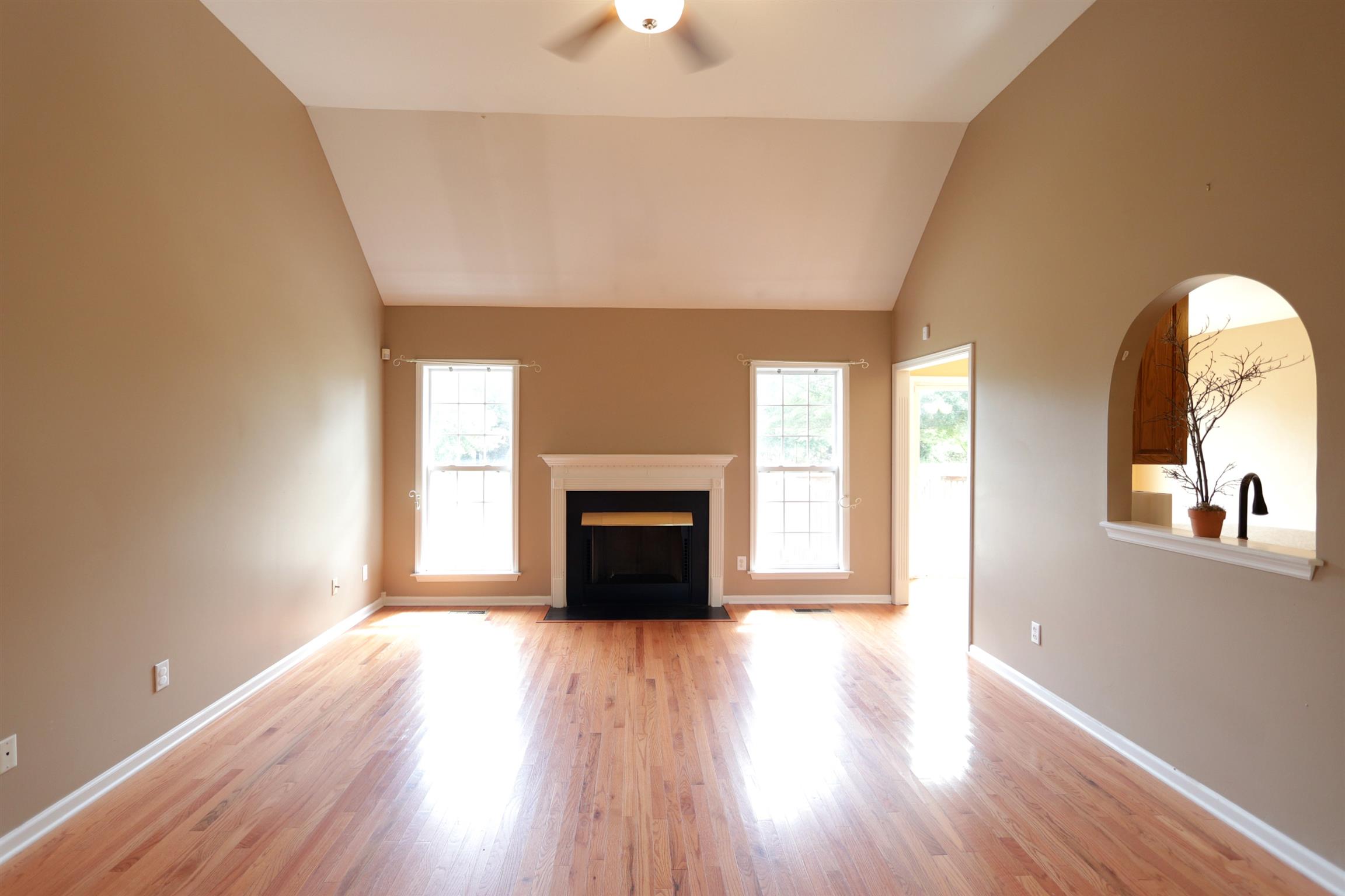 833 Rands Way Columbia, TN 38401 - Photo 8 of 27 a view of a livingroom with wooden floor a fireplace and windows