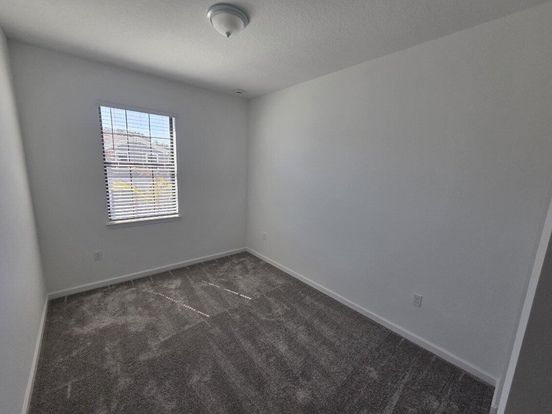 7783 Southwest Bentley Lane Stuart, FL 34997 - Photo 15 of 34 an empty room with a window