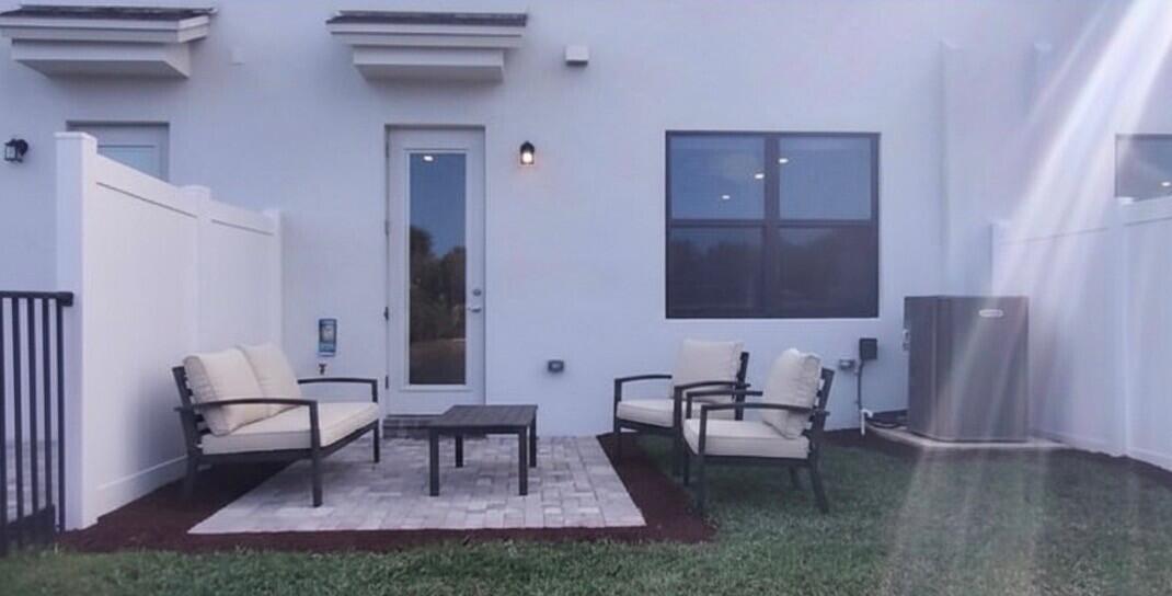 7783 Southwest Bentley Lane Stuart, FL 34997 - Photo 26 of 34 a living room with furniture and a lamp