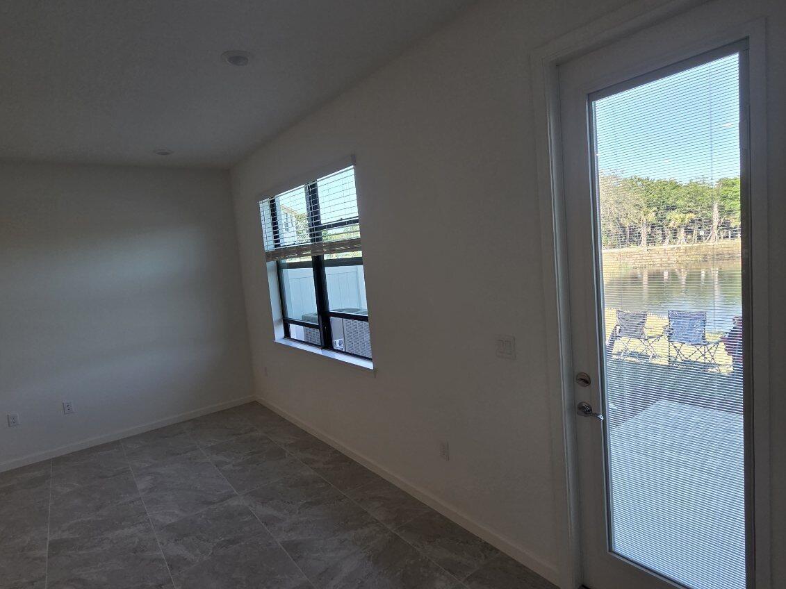 7783 Southwest Bentley Lane Stuart, FL 34997 - Photo 10 of 34 an empty room with windows