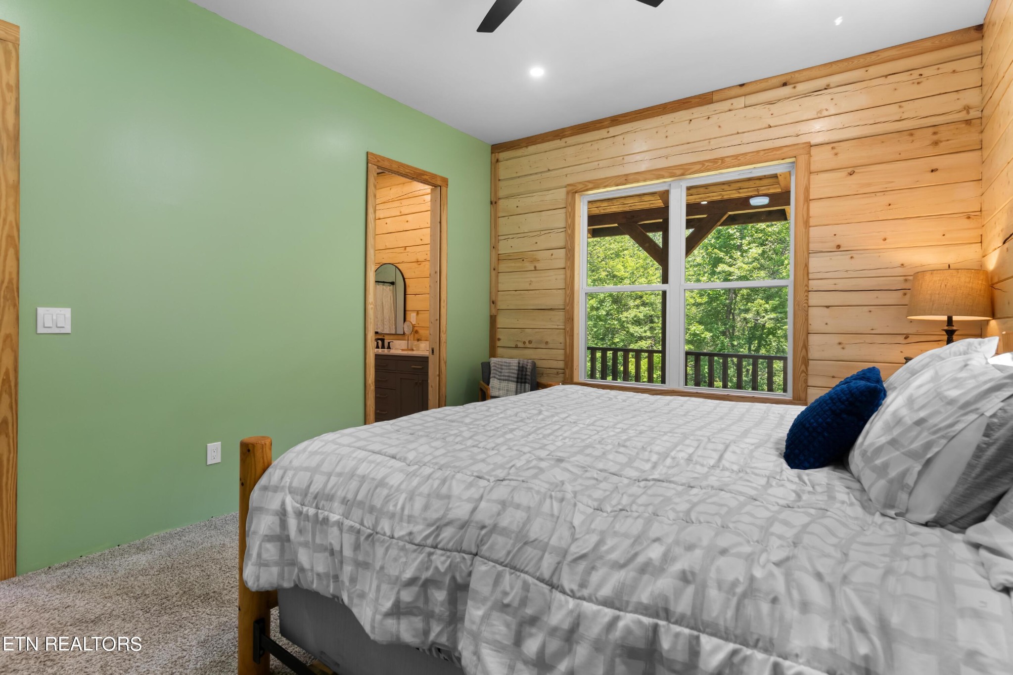 157 Foust Hollow Road Heiskell, TN 37754 - Photo 14 of 34 a bedroom with a bed and large windows