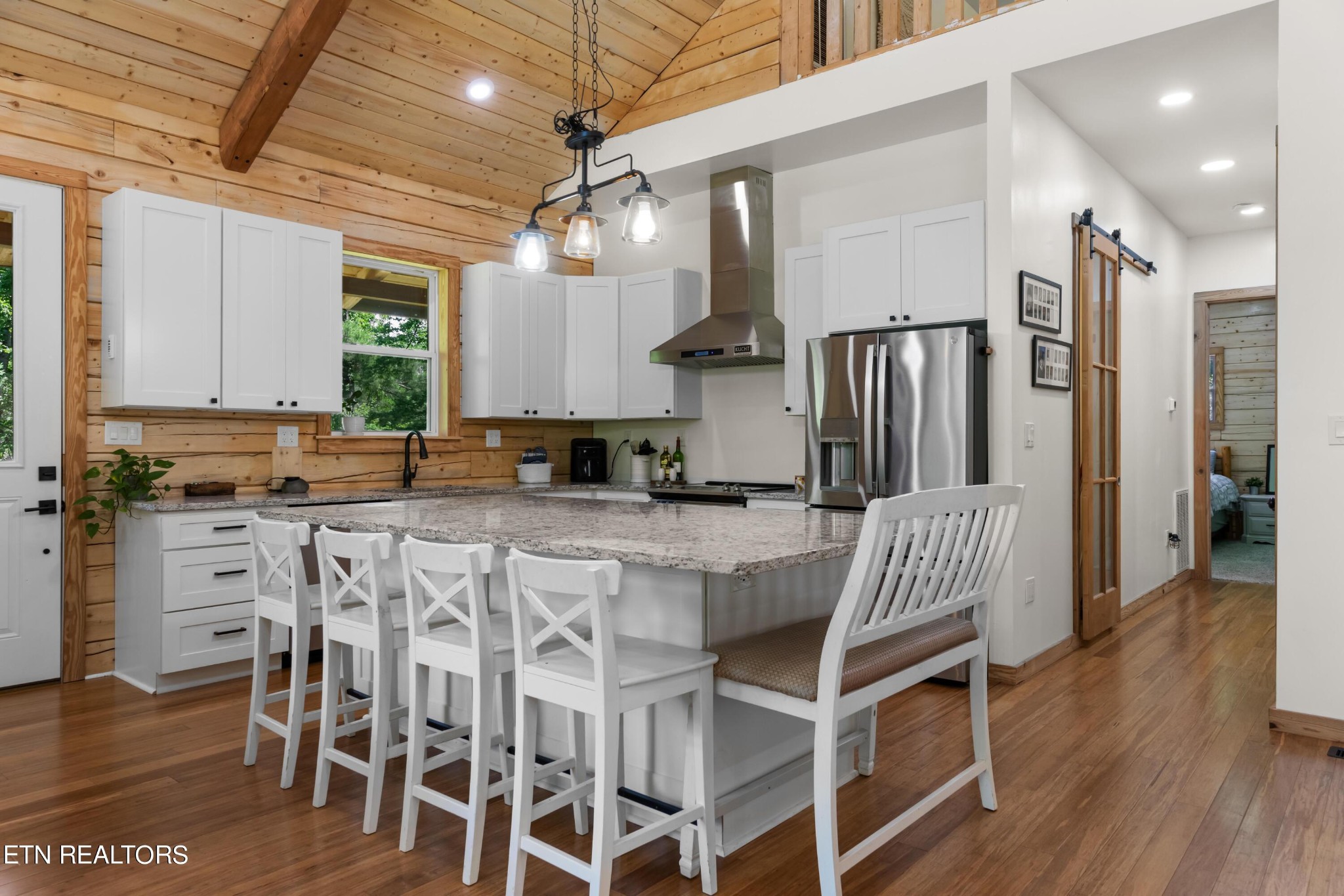 157 Foust Hollow Road Heiskell, TN 37754 - Photo 7 of 34 a kitchen with stainless steel appliances granite countertop a dining table chairs refrigerator and cabinets
