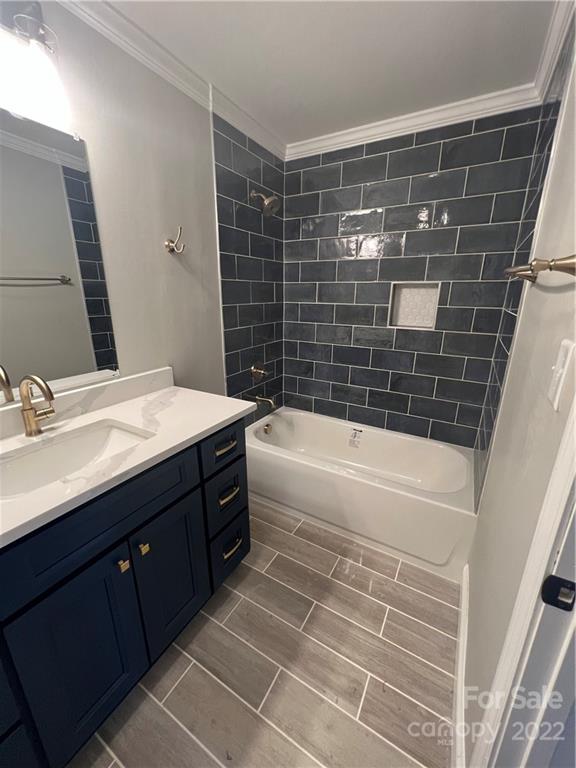 7545 Tuckaseegee Road Kannapolis, NC 28081 - Photo 16 of 20 a bathroom with a bathtub sink vanity and a mirror