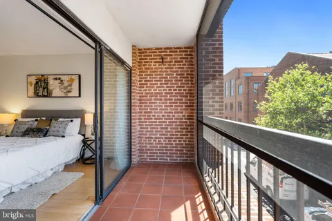 a view of a balcony and car parked