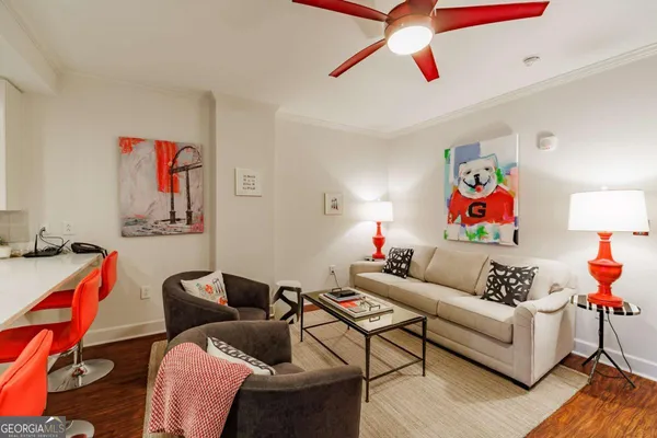 a living room with furniture a rug and a lamp