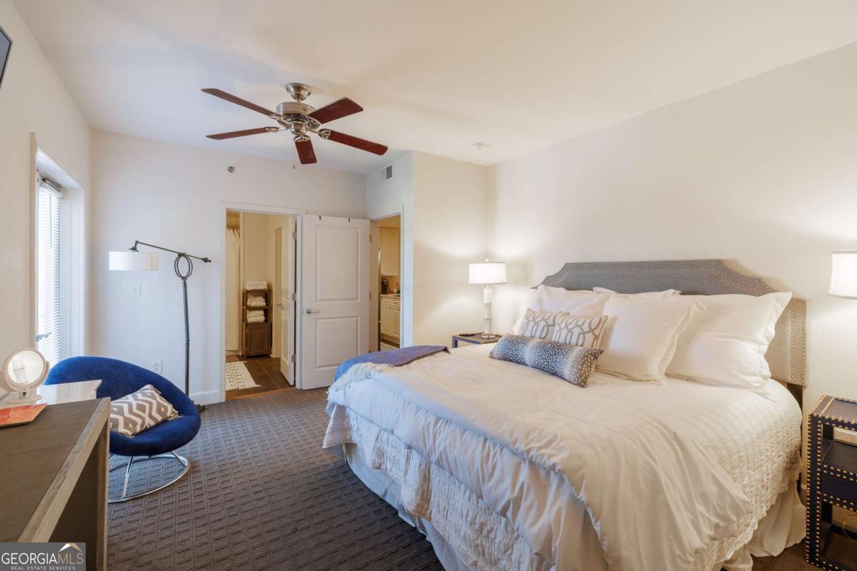 250 West Broad Street, Unit 714 Athens, GA 30601 - Photo 12 of 21 a bedroom with a bed and wooden floor