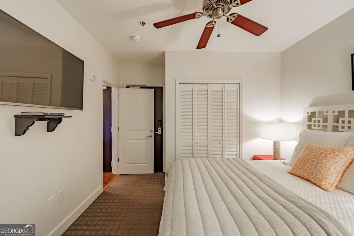 250 West Broad Street, Unit 714 Athens, GA 30601 - Photo 18 of 21 a bedroom with a bed and a chandelier