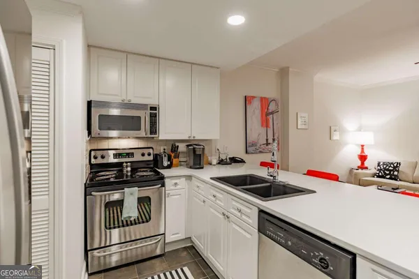 a kitchen that has a sink and a stove in it