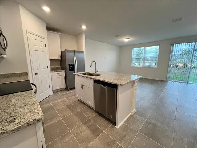 a kitchen with a sink stove and refrigerator
