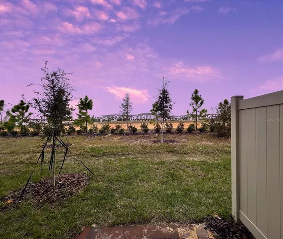 a view of a house with a yard and sitting area