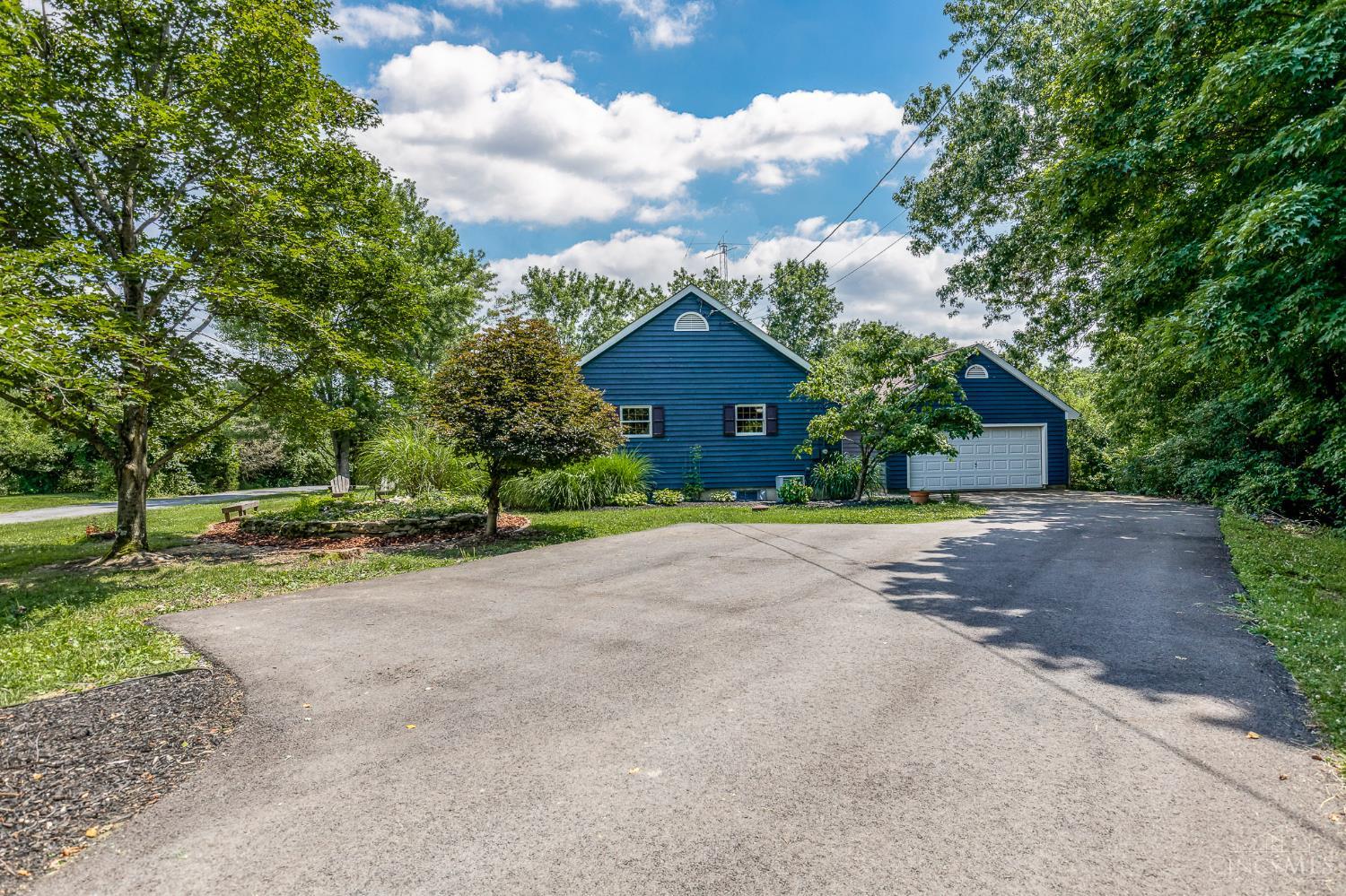 623 Ibold Road Loveland, OH 45140 - Photo 27 of 35 Set back on a scenic one-acre lot, the home is complemented by an oversized driveway, detached two-car garage, and thoughtfully landscaped grounds that enhance both privacy and curb appeal.