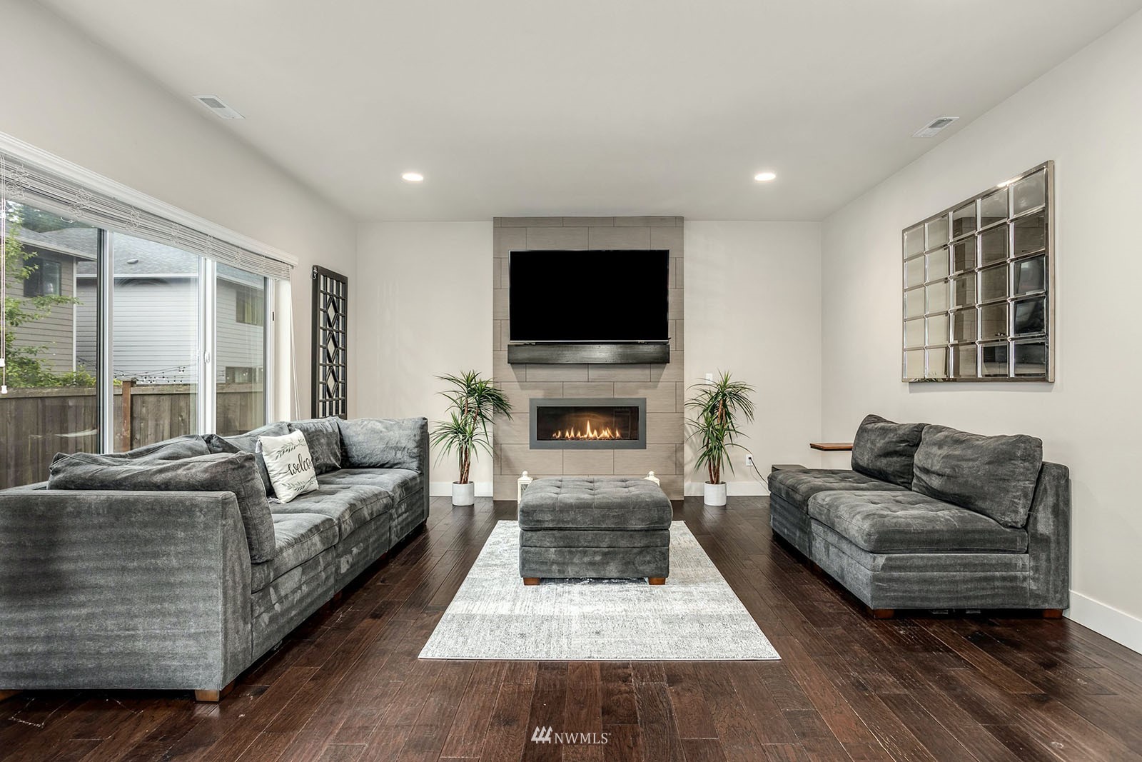 18005 44th Avenue Southeast Bothell, WA 98012 - Photo 11 of 30 a living room with furniture a flat screen tv and a fireplace