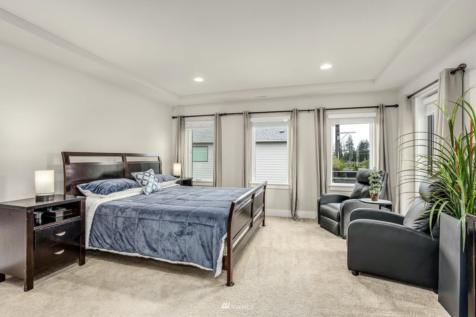 18005 44th Avenue Southeast Bothell, WA 98012 - Photo 16 of 30 a bedroom with a bed couch and potted plant on the dresser