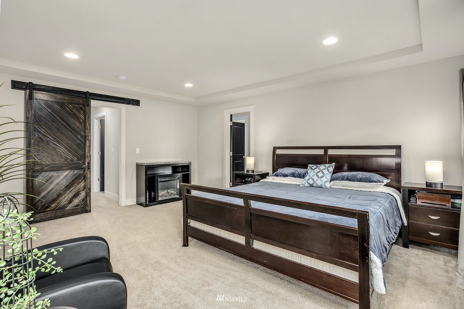 18005 44th Avenue Southeast Bothell, WA 98012 - Photo 17 of 30 a bedroom with a bed couch and flat screen tv