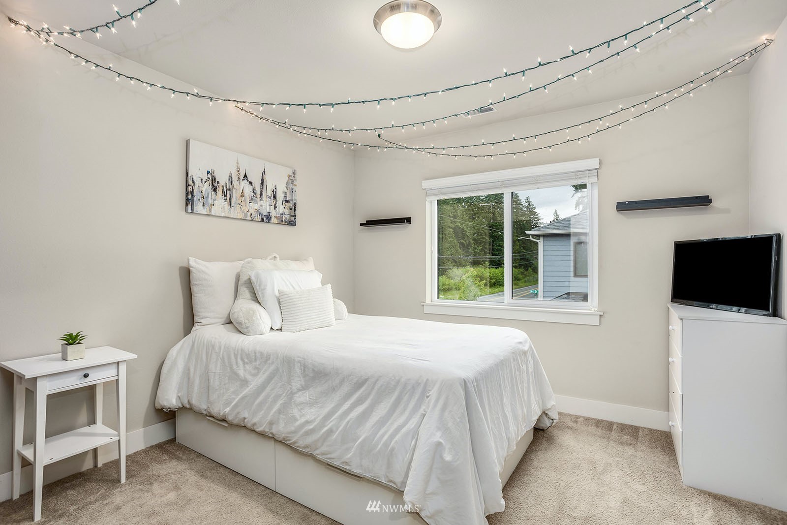 18005 44th Avenue Southeast Bothell, WA 98012 - Photo 21 of 30 a bedroom with a bed and a flat screen tv