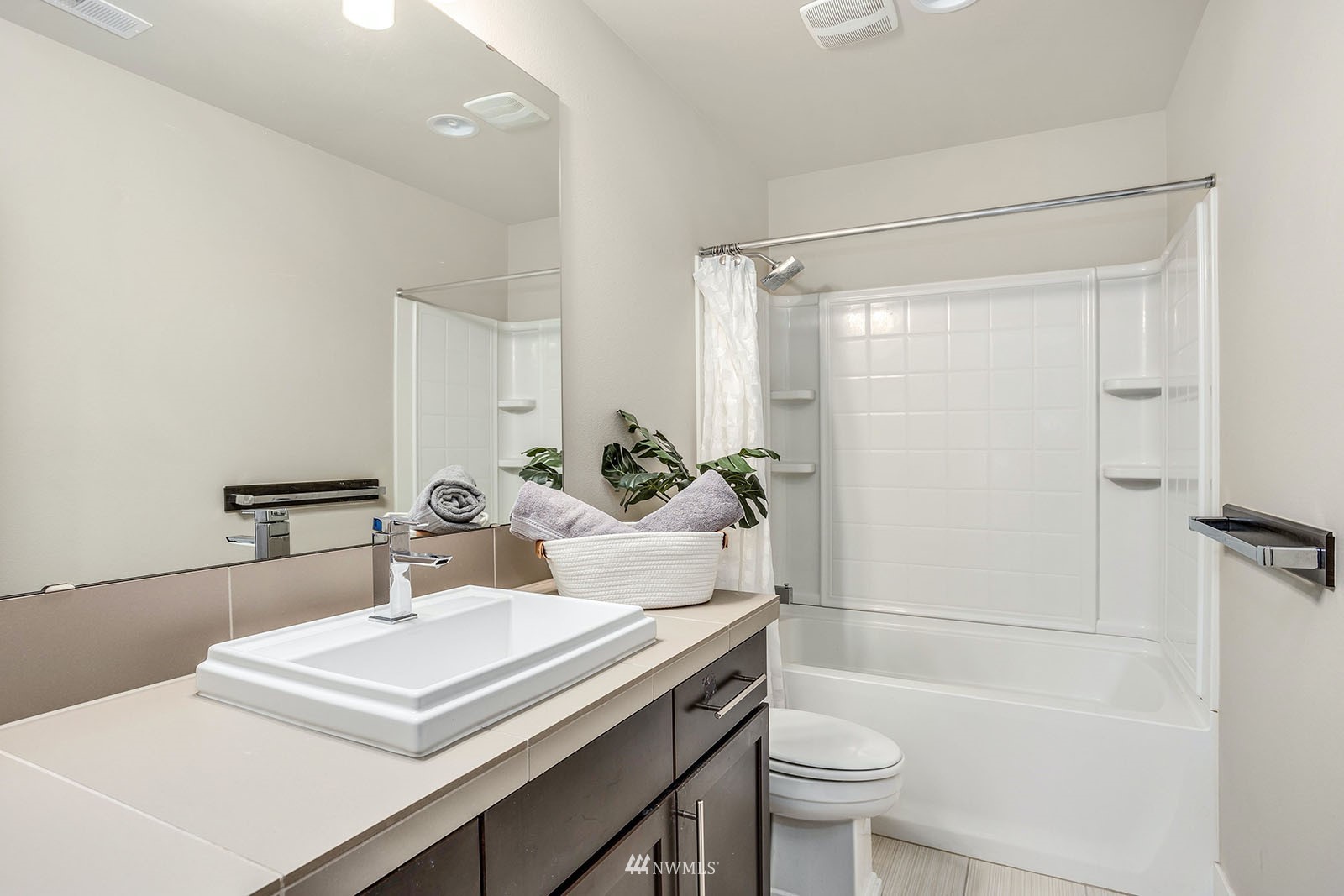 18005 44th Avenue Southeast Bothell, WA 98012 - Photo 24 of 30 a bathroom with a sink a toilet a mirror and shower