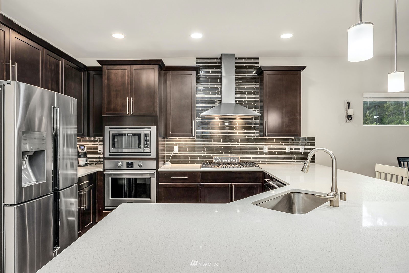 18005 44th Avenue Southeast Bothell, WA 98012 - Photo 6 of 30 a kitchen with stainless steel appliances a sink stove and refrigerator