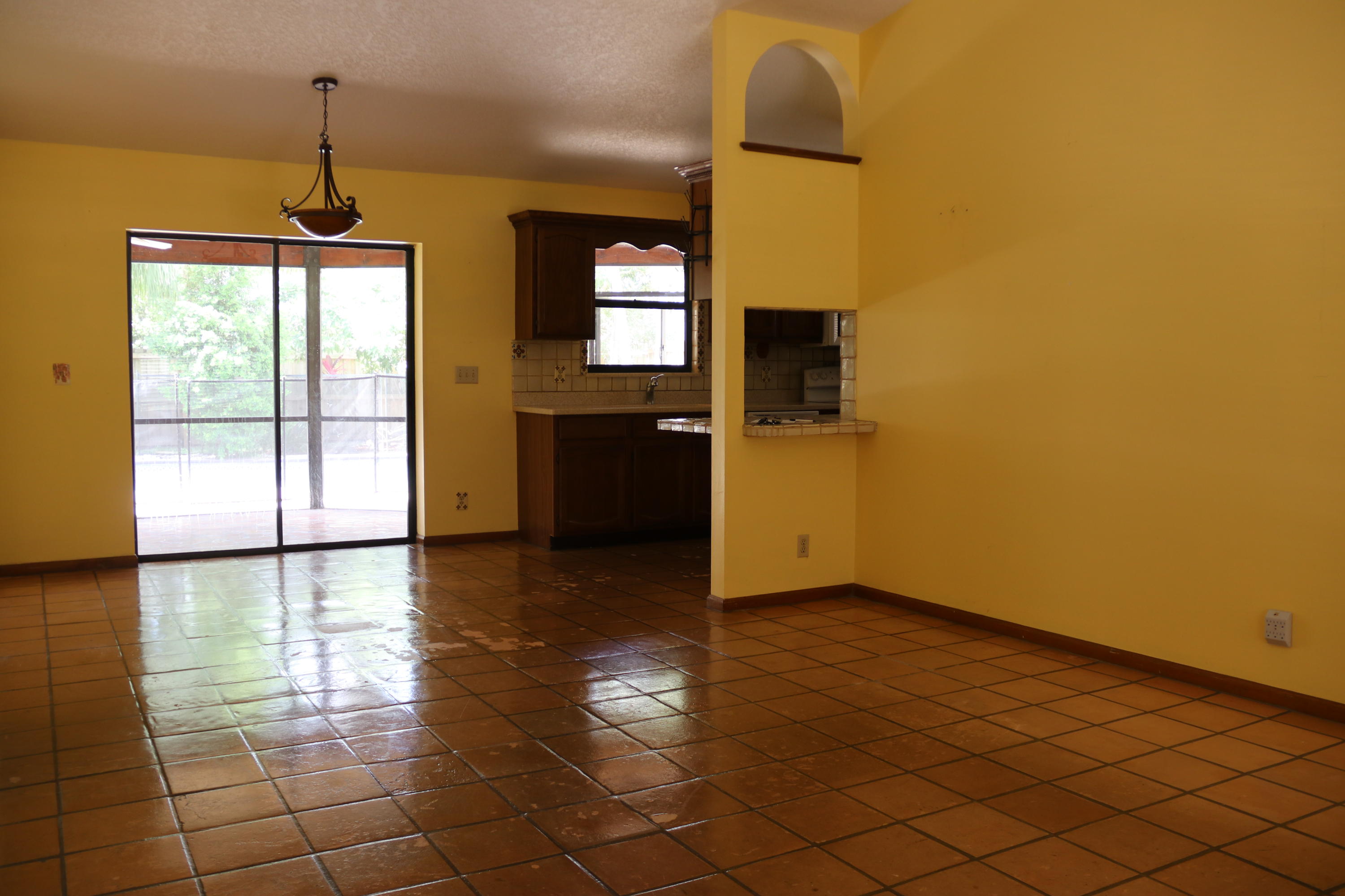 6098 Kendrick Street Jupiter, FL 33458 - Photo 12 of 15 a view of empty room with wooden floor and fan
