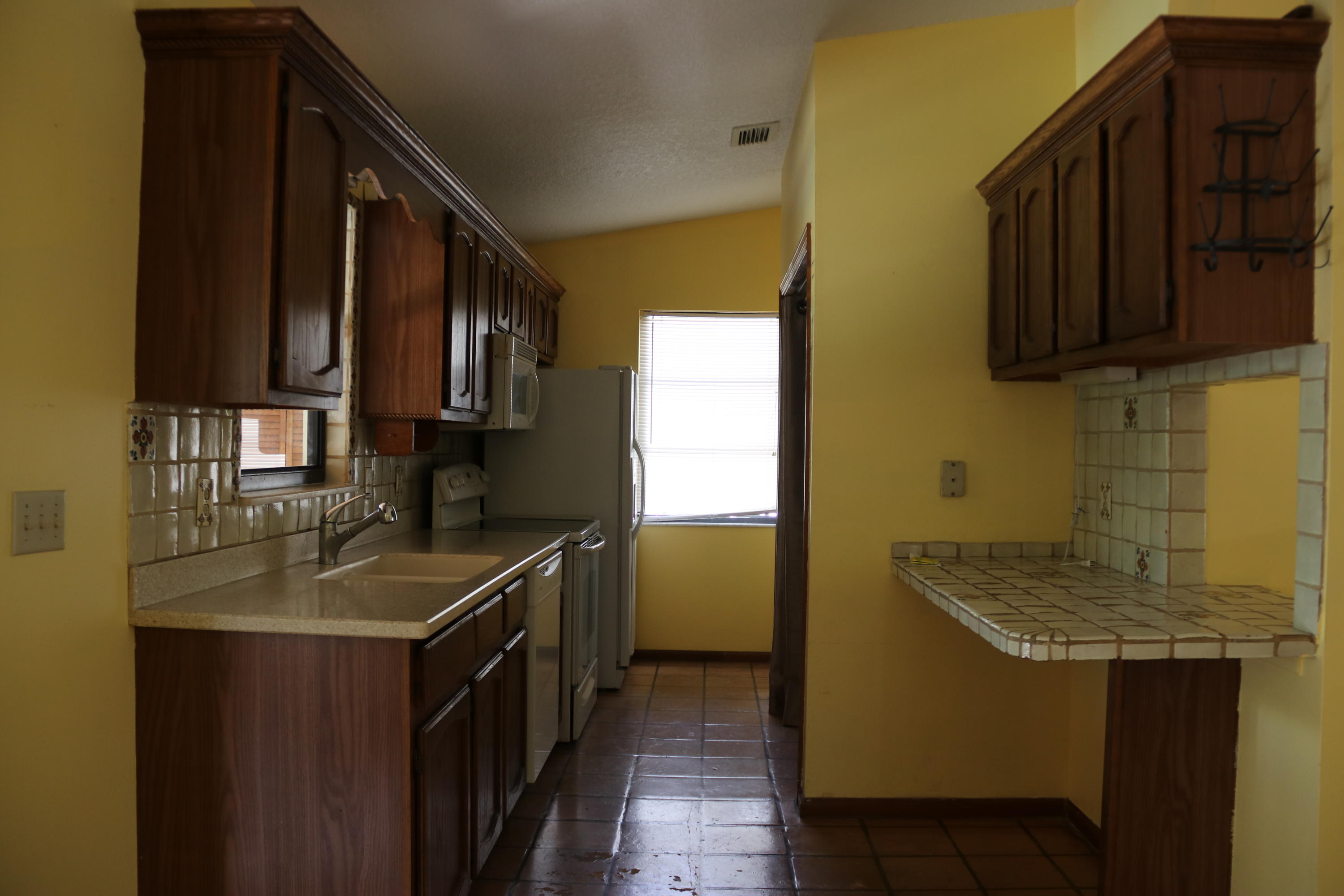 6098 Kendrick Street Jupiter, FL 33458 - Photo 3 of 15 a kitchen with a sink a stove and cabinets