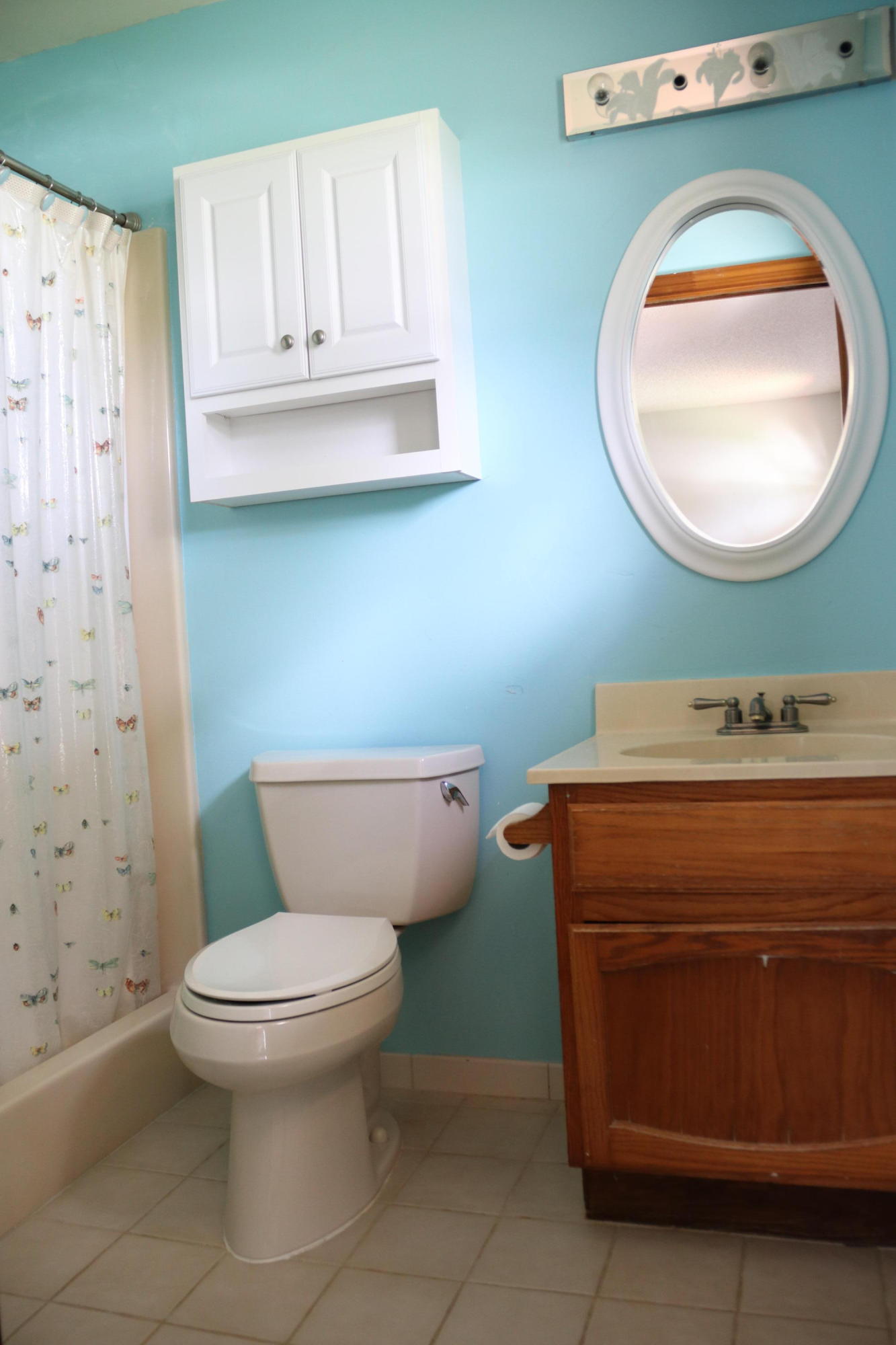 6098 Kendrick Street Jupiter, FL 33458 - Photo 5 of 15 a bathroom with a toilet a sink and mirror