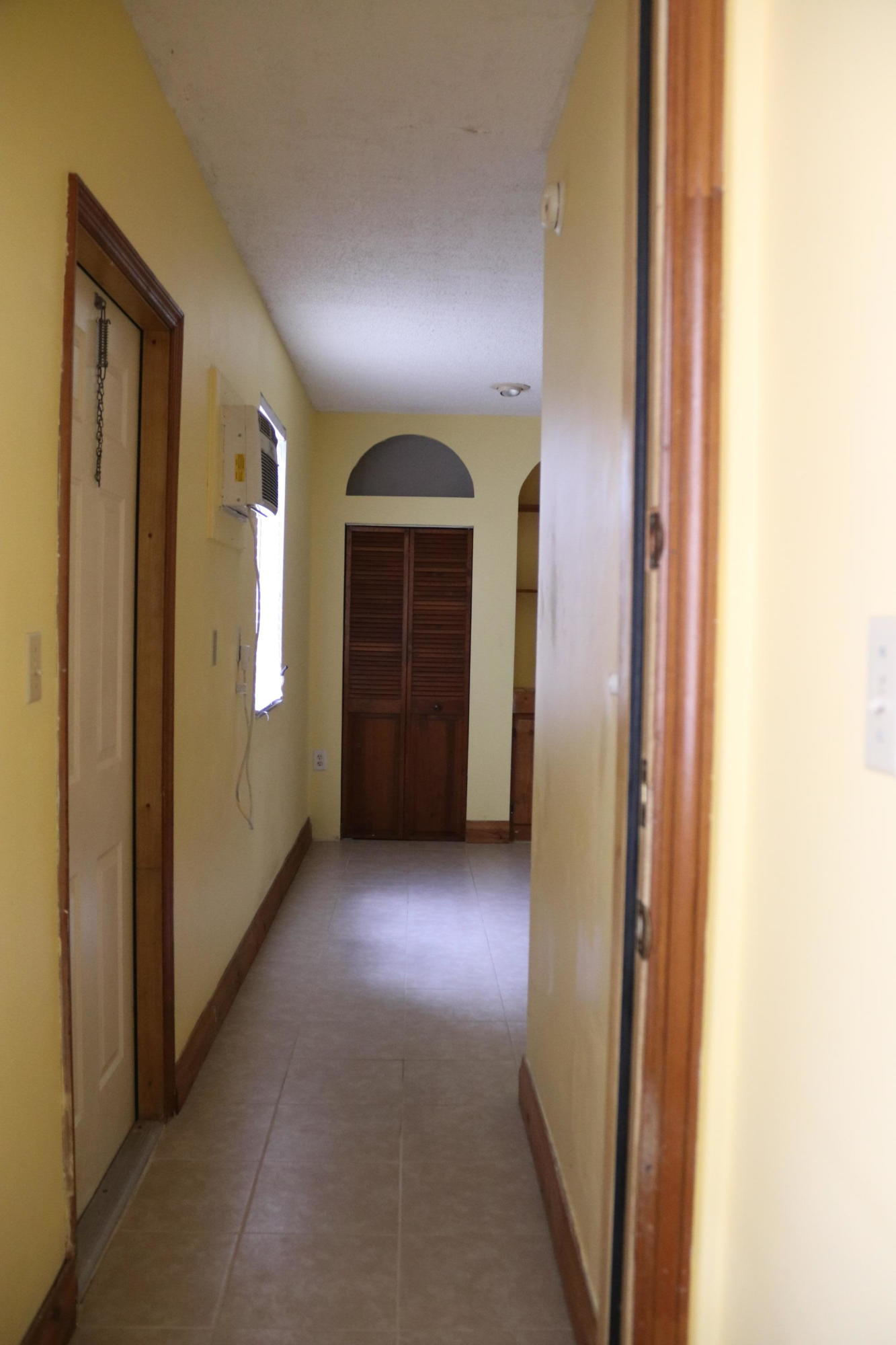 6098 Kendrick Street Jupiter, FL 33458 - Photo 10 of 15 a view of a hallway with wooden shelves