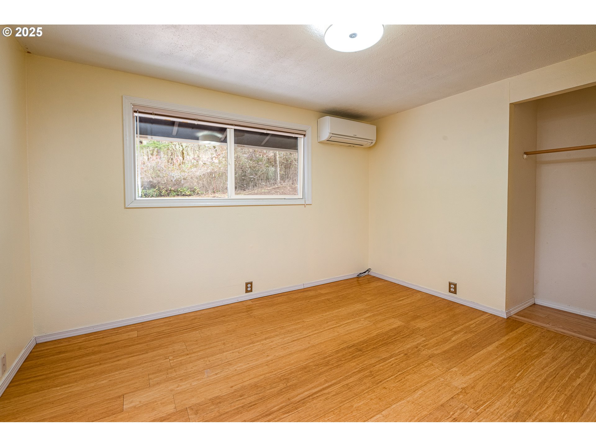 293 Brae Burn Drive Eugene, OR 97405 - Photo 21 of 35 a view of an empty room with wooden floor and a window