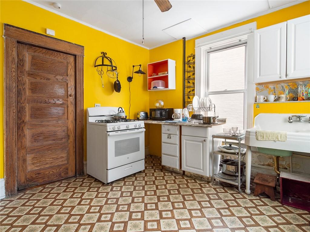 446 76th Street Brooklyn, NY 11209 - Photo 11 of 35 a kitchen with a sink stove and cabinets