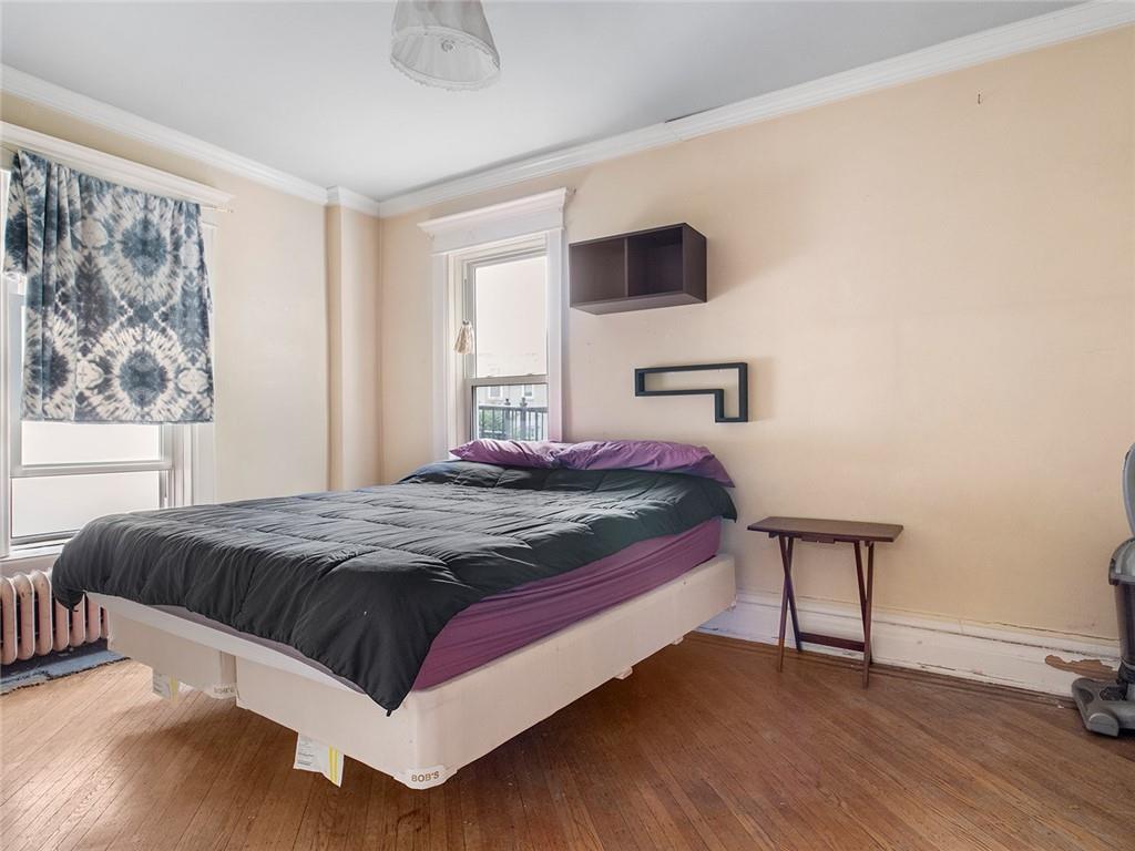 446 76th Street Brooklyn, NY 11209 - Photo 16 of 35 a bedroom with a bed and a window