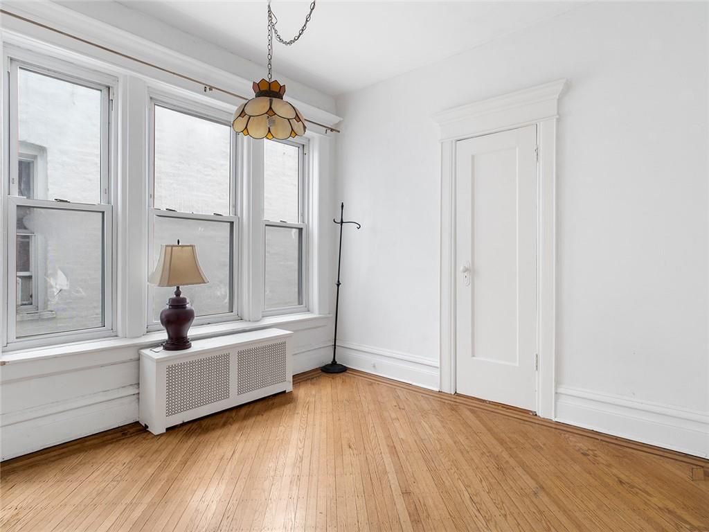 446 76th Street Brooklyn, NY 11209 - Photo 18 of 35 a bedroom with a bed and a window
